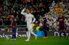 Real Madrid's Sergio Ramos celebrates as he runs past Barcelona's Lionel Messi during the Spanish La Liga soccer match between Real Madrid and Barcelona at the Santiago Bernabeu stadium in Madrid, Spain, Sunday, March 1, 2020. (AP Photo/Andrea Comas)