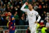 Real Madrid's Sergio Ramos celebrates as he runs past Barcelona's Lionel Messi during the Spanish La Liga soccer match between Real Madrid and Barcelona at the Santiago Bernabeu stadium in Madrid, Spain, Sunday, March 1, 2020. (AP Photo/Andrea Comas)