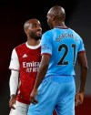 West Ham's Angelo Ogbonna and Arsenal's Alexandre Lacazette confront each other during the English Premier League soccer match between Arsenal and West Ham at the Emirates Stadium in London, England, Saturday, Sept. 19, 2020. (AP Photo/Ian Walton, Pool)