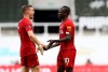 Liverpool's Sadio Mane, right, celebrates with James Milner after scoring his side's third goal during the English Premier League soccer match between Newcastle and Liverpool at St. James' Park in Newcastle, England, Sunday, July 26, 2020. (Owen Humphreys, Pool via AP)