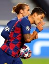 Barcelona's Luis Suarez, right, celebrates with Barcelona's Antoine Griezmann after scoring a goal during the Champions League quarterfinal soccer match between Barcelona and Bayern Munich in Lisbon, Portugal, Friday, Aug. 14, 2020. (Rafael Marchante/Pool via AP)