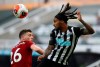 Liverpool's Andrew Robertson, left, challenges Newcastle's Valentino Lazaro during the English Premier League soccer match between Newcastle and Liverpool at St. James' Park in Newcastle, England, Sunday, July 26, 2020. (Owen Humphreys, Pool via AP)