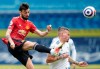 Manchester United's Bruno Fernandes clears the ball from Leeds United's Kalvin Phillips during the English Premier League soccer match between Leeds United and Manchester United at Elland Road in Leeds, England, Sunday April 25, 2021. (AP Photo/Jon Super, Pool)