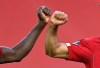 Liverpool's Mohamed Salah, right, celebrates after scoring the second goal with Sadio Mane during the English Premier League soccer match between Liverpool and Crystal Palace at Anfield Stadium in Liverpool, England, Wednesday, June 24, 2020. (Paul Ellis/Pool via AP)