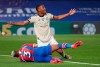 Manchester United's Anthony Martial, top left, celebrates after scoring his side's second goal during the English Premier League soccer match between Crystal Palace and Manchester United at Selhurst Park in London, England, Thursday, July 16, 2020. At bottom left is Crystal Palace's Patrick van Aanholt who was injured in the build-up to the goal. (AP Photo/Peter Cziborra, Pool)