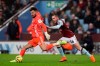 Watford goalkeeper Ben Foster clears under pressure from Aston Villa's Indiana Vassilev during the English Premier League match at Villa Park, Birmingham, England, Tuesday Jan. 21, 2020. (David Davies/PA via AP)