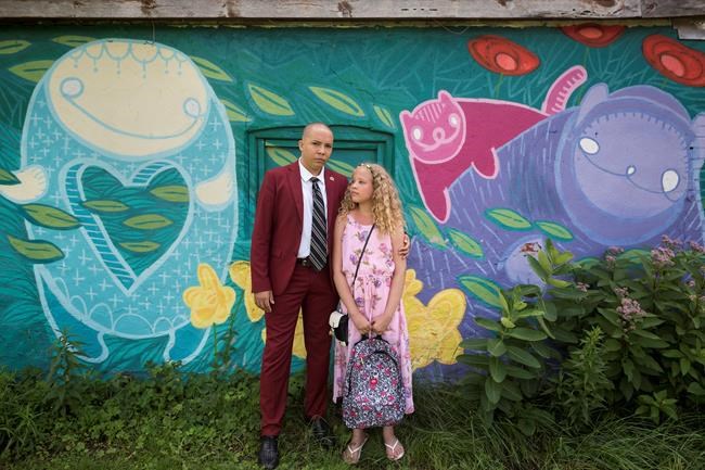Vonny Sweetland and his sister, who he is a guardian for, Josephine Price, 12, pose for a photograph at Wychwood Barns Park in Toronto, on Saturday, August 15, 2020. Vonny Sweetland has yet to decide if he will be sending his 12-year-old sister Josephine back to class in September, but just in case he does, he's been stocking up on supplies for months. THE CANADIAN PRESS/ Tijana Martin