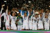 FILE - In this Nov. 10, 2018, file photo, Kashima Antlers' Mitsuo Ogasawara, center, holds up the trophy as he celebrates with teammates after winning the Asian Champions League at the end of their match with Iran's Persepolis the Azadi (freedom) stadium in Tehran, Iran. When the decision was made in 2013 to split the Asian Champions League into east and west geographic zones, it was unthinkable that a team from one half of the continent could book a place in the Grand Final weeks before some clubs on the other side hadn‚Äôt started the group stage. Such a lopsided scenario will likely become a reality in 2020. (AP Photo/Vahid Salemi)