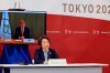 International Olympic Committee (IOC) President Thomas Bach, on a screen, delivers an opening speech while Tokyo 2020 Organizing Committee President Seiko Hashimoto listens at a five-party meeting of Tokyo 2020 Olympic and Paralympic Games with International Paralympic Committee (IPC) President Andrew Parsons, Tokyo Gov. Yuriko Koike and Japanese Olympic Minister Tamayo Marukawa in Tokyo Saturday, March 20, 2021. (Yoshikazu Tsuno/Pool Photo via AP)