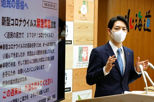 Hokkaido Gov. Naomichi Suzuki speaks at a press conference at the Hokkaido Government in Sapporo, northern Japan Friday, Feb. 28, 2020. The Japanese island of Hokkaido is declaring a state of emergency over the rapid spread of the new virus there. (Yohei Fukai/Kyodo News via AP)