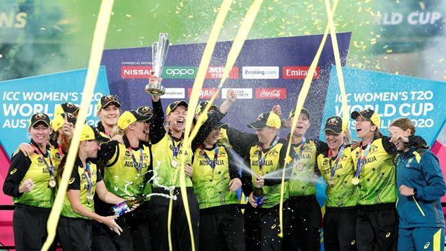 FILE - In this March 8, 2020, file photo, Australian players celebrate their win over India in the Women's T20 World Cup cricket final match in Melbourne. A three-match one-day international series between the Australia and India women's cricket teams has been postponed indefinitely and likely won't be played until 2022. (AP Photo/Asanka Ratnayake, File)