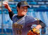 In this March 11, 2020, photo, Hanshin Tigers pitcher Shintaro Fujinami throws a ball against Yakult Swallows in a pre-season match in Tokyo. Fujinami became the first professional baseball player in Japan to test positive for the new coronavirus. Fujinami was examined at a hospital on Tuesday, March 24, and Wednesday, March 25, and a doctor recommended he have a PCR test for the new coronavirus. Kyodo News agency reported on Friday, March 27, that the result was positive.(Kyodo News via AP)