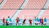 In this March 28, 2020, photo, players of Nagoya Grampus and Yokohama FC play during a practice game, without spectators following the outbreak of the new coronavirus, in Toyota, central Japan. Japan's soccer J-League will resume on July 4 after stopping play in the early season as the coronavirus began to surge. (Kyodo News via AP)