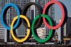 FILE - In this Dec. 1, 2020, file photo, the Olympic Symbol is reinstalled after it was taken down for maintenance ahead of the postponed Tokyo 2020 Olympics in the Odaiba section in Tokyo. More than 80% of people in Japan who were surveyed in two polls in the last few days say the Tokyo Olympics should be canceled or postponed, or say they believe the Olympics will not take place. (AP Photo/Eugene Hoshiko, File)