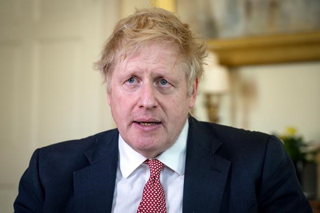 FILE - In this April 12, 2020, file photo issued by 10 Downing Street, Britain's Prime Minister Boris Johnson speaks from 10 Downing Street praising NHS staff in a video message after he was discharged from hospital a week after being admitted with persistent coronavirus symptoms, in London. Johnson was the first major world leader confirmed to have COVID-19. He was moved to intensive care in April after his virus symptoms dramatically worsened a day after he was hospitalized for what were called routine tests. (Pippa Fowles/10 Downing Street via AP, File)