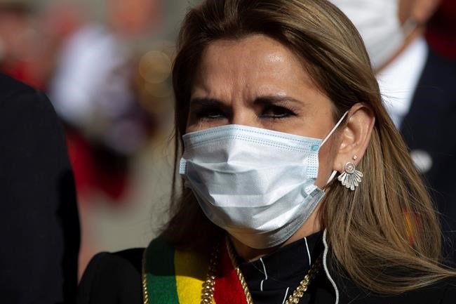 FILE - In this Aug. 6, 2020, file photo, Bolivia's interim President Jeanine Anez, wearing a mask amid the coronavirus pandemic, attends an Independence Day event in La Paz, Bolivia. The virus drove Anez into isolation in July, but she said she was feeling well. (AP Photo/Juan Karita, File)