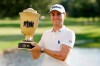 Justin Thomas holds the trophy after winning the World Golf Championship-FedEx St. Jude Invitational Sunday, Aug. 2, 2020, in Memphis, Tenn. (AP Photo/Mark Humphrey)