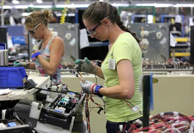 FILE - In this Sept. 20, 2019, file photo, Maurine Carter works on the wiring of a stove in LaFayette, Ga. Orders to American factories for big-ticket goods rebounded last month from a disastrous April as the U.S. economy began to slowly reopen. The Commerce Department said that orders for manufactured goods meant to last at least three years shot up 15.8% in May after plunging 18.1% in April.(Erin O. Smith/Chattanooga Times Free Press via AP, File)