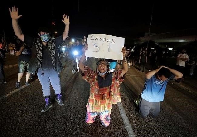 Protesters kneel in front of the Union Avenue police station in Memphis, Tenn., during a protest over the death of George Floyd, Thursday, May 28, 2020, in Memphis, Tenn. (Patrick Lantrip/Daily Memphian via AP)