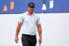 Brooks Koepka walks across the practice green at the World Golf Championships-FedEx St. Jude Invitational Wednesday, July 29, 2020, in Memphis, Tenn. Koepka, who won three times last year is trying to defend his FedEx St. Jude Invitational title with an injured left knee that has had him putting more weight on his right leg and affecting his game. (AP Photo/Mark Humphrey)