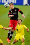 D.C. United midfielder Julian Gressel (31) heads the ball away from Nashville SC defender Taylor Washington, right, during the first half of an MLS soccer match Wednesday, Sept. 23, 2020, in Nashville, Tenn. (AP Photo/Mark Humphrey)