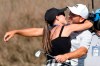 Sergio Garcia, of Spain, gets a kiss from his wife, Angela Akins, after Garcia made a hole in one on the fourth hole to win his playoff against Lee Westwood, of England, during a third round match at the Dell Technologies Match Play Championship golf tournament Friday, March 26, 2021, in Austin, Texas. (AP Photo/David J. Phillip)