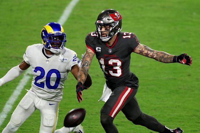 Los Angeles Rams cornerback Jalen Ramsey (20) knocks a pass away from Tampa Bay Buccaneers wide receiver Mike Evans (13) during the first half of an NFL football game Monday, Nov. 23, 2020, in Tampa, Fla. (AP Photo/Mark LoMoglio)