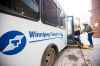 MIKAELA MACKENZIE / WINNIPEG FREE PRESS FILES
A Transit Plus passenger is loaded on to a bus at a stop on Portage Avenue in Winnipeg.