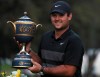 Patrick Reed of the United States poses with the trophy after winning the WGC-Mexico Championship golf tournament, at the Chapultepec Golf Club in Mexico City, Sunday, Feb. 23, 2020. (AP Photo/Fernando Llano)