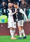 Juventus' Cristiano Ronaldo, right, celebrates with teammate Gonzalo Higuain after scoring his second goal during the Italian Serie A soccer match between Juventus and Udinese at the Allianz Stadium in Turin, Italy, Sunday, Dec. 15, 2019. (Alessandro Di Marco/ANSA via AP)