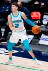 Charlotte Hornets guard LaMelo Ball (2) looks for room against the Dallas Mavericks defense during the second half of an NBA basketball game, Wednesday, Dec. 30, 2020, in Dallas. (AP Photo/Brandon Wade)