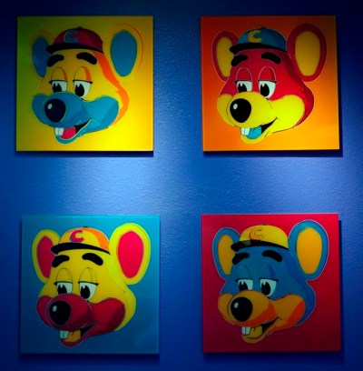 FILE - This Jan. 16, 2014 file photo shows paintings hanging on a wall at Chuck E. Cheese's in Dallas. Chuck E. Cheese pizzeria, that Mecca of fun for children but the bane of many parents, is filing for bankruptcy protection. CEC Entertainment Inc. said Thursday, Jan. 25, 2020, it was filing for voluntary protection under Chapter 11 “in order to overcome the financial strain resulting from prolonged, COVID-19 related venue closures.” (G.J. McCarthy/The Dallas Morning News via AP)