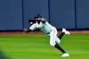 Miami Marlins right fielder Lewis Brinson (25) makes a running catch for the third out on a ball hit by Atlanta Braves' Travis d'Arnaud in the eighth inning in Game 3 of a baseball National League Division Series, Thursday, Oct. 8, 2020, in Houston. (AP Photo/David J. Phillip)