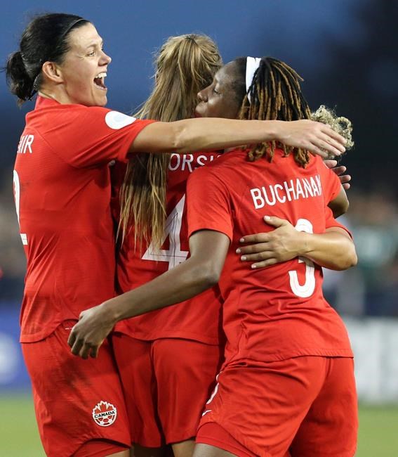 Canada's Christine Sinclair (19) and teammates Shelina Zadorsky(4) and Kadeisha Buchanan (5) celebrate a goal during a CONCACAF women's Olympic qualifying soccer match against Mexico, Tuesday, Feb. 4, 2020, in Edinburg, Texas. (AP Photo/Delcia Lopez)