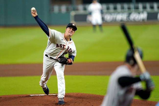Houston Astros starting pitcher Zack Greinke, left, throws to Arizona Diamondbacks' Christian Walker during the first inning of a baseball game Friday, Sept. 18, 2020, in Houston. (AP Photo/David J. Phillip)