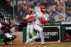 Los Angeles Angels' Jared Walsh, right, hits a home run as Houston Astros catcher Jason Castro watches during the sixth inning of a baseball game Monday, May 10, 2021, in Houston. (AP Photo/David J. Phillip)