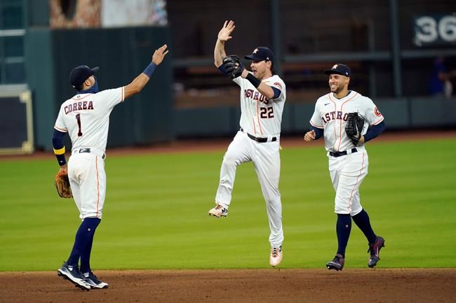 Houston Astros' Carlos Correa (1), Josh Reddick (22) and George Springer celebrate after a baseball game against the Texas Rangers Thursday, Sept. 17, 2020, in Houston. The Astros won 2-1. (AP Photo/David J. Phillip)