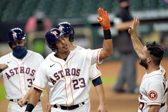 Houston Astros' Michael Brantley (23) celebrates with Jose Altuve, right, after hitting a three-run home run against the Texas Rangers during the seventh inning of a baseball game Tuesday, Sept. 1, 2020, in Houston. (AP Photo/David J. Phillip)