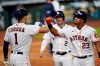 Houston Astros' Michael Brantley (23) celebrates with Carlos Correa (1) after hitting a three-run home run against the Seattle Mariners during the fifth inning of a baseball game Friday, July 24, 2020, in Houston. (AP Photo/David J. Phillip)