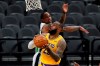 Los Angeles Lakers forward LeBron James (23) scores past San Antonio Spurs guard DeMar DeRozan during the first half of an NBA basketball game in San Antonio, Wednesday, Dec. 30, 2020. (AP Photo/Eric Gay)