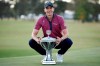 Carlos Ortiz poses with the champion's trophy after winning the Houston Open golf tournament, Sunday, Nov. 8, 2020, in Houston. (AP Photo/Eric Christian Smith)