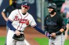 Atlanta Braves first baseman Freddie Freeman, left, taps Miami Marlins' Miguel Rojas, right, on the hip after Rojas was hit by a pitch during the eighth inning in Game 1 of a baseball National League Division Series Tuesday, Oct. 6, 2020, in Houston. The Braves won 9-5. (AP Photo/Michael Wyke)