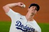 Los Angeles Dodgers starting pitcher Walker Buehler (21) throws against the San Diego Padres during the first inning in Game 1 of a baseball NL Division Series, Tuesday, Oct. 6, 2020, in Arlington, Texas. (AP Photo/Tony Gutierrez)