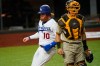 Los Angeles Dodgers third baseman Justin Turner (10) scores on a hit by center fielder Cody Bellinger behind San Diego Padres catcher Austin Nola during the fifth inning in Game 1 of a baseball NL Division Series, Tuesday, Oct. 6, 2020, in Arlington, Texas. (AP Photo/Sue Ogrocki)