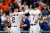 Houston Astros' Alex Bregman (2) and Carlos Correa (1) celebrate Correa's home run against the Los Angeles Angels during the first inning of a baseball game Saturday, April 24, 2021, in Houston. (AP Photo/Michael Wyke)
