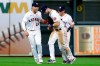 Houston Astros' outfielders Aledmys Diaz (16), Kyle Tucker, middle, and Myles Straw celebrate the team's 7-5 win over the Seattle Mariners in a baseball game Wednesday, April 28, 2021, in Houston. (AP Photo/Michael Wyke)