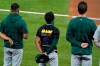 Oakland Athletics' Tony Kemp wears a Black Lives Matter shirt as he stands with his team during the playing of the national anthem before a baseball game against the Texas Rangers in Arlington, Texas, Wednesday Aug. 26, 2020. (AP Photo/Tony Gutierrez)