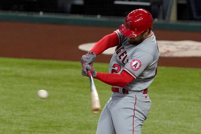Los Angeles Angels' Jared Walsh connects for a three-run home run in the first inning of a baseball game against the Texas Rangers in Arlington, Texas, Thursday, Sept. 10, 2020. The home run also scored Anthony Rendon and Mike Trout. (AP Photo/Tony Gutierrez)