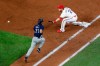 Texas Rangers first baseman Todd Frazier (21) reaches out for the throw to the bag against Seattle Mariners’ Austin Nola’s infield groundout in the second inning of a baseball game in Arlington, Texas, Monday, Aug. 10, 2020. (AP Photo/Tony Gutierrez)