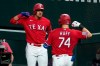 Texas Rangers' Ronald Guzman, left, and Sam Huff (74) celebrate after Huff hit a solo home run off a pitch from Houston Astros' Jose Urquidy in the second inning of a baseball game in Arlington, Texas, Friday, Sept. 25, 2020. (AP Photo/Tony Gutierrez)